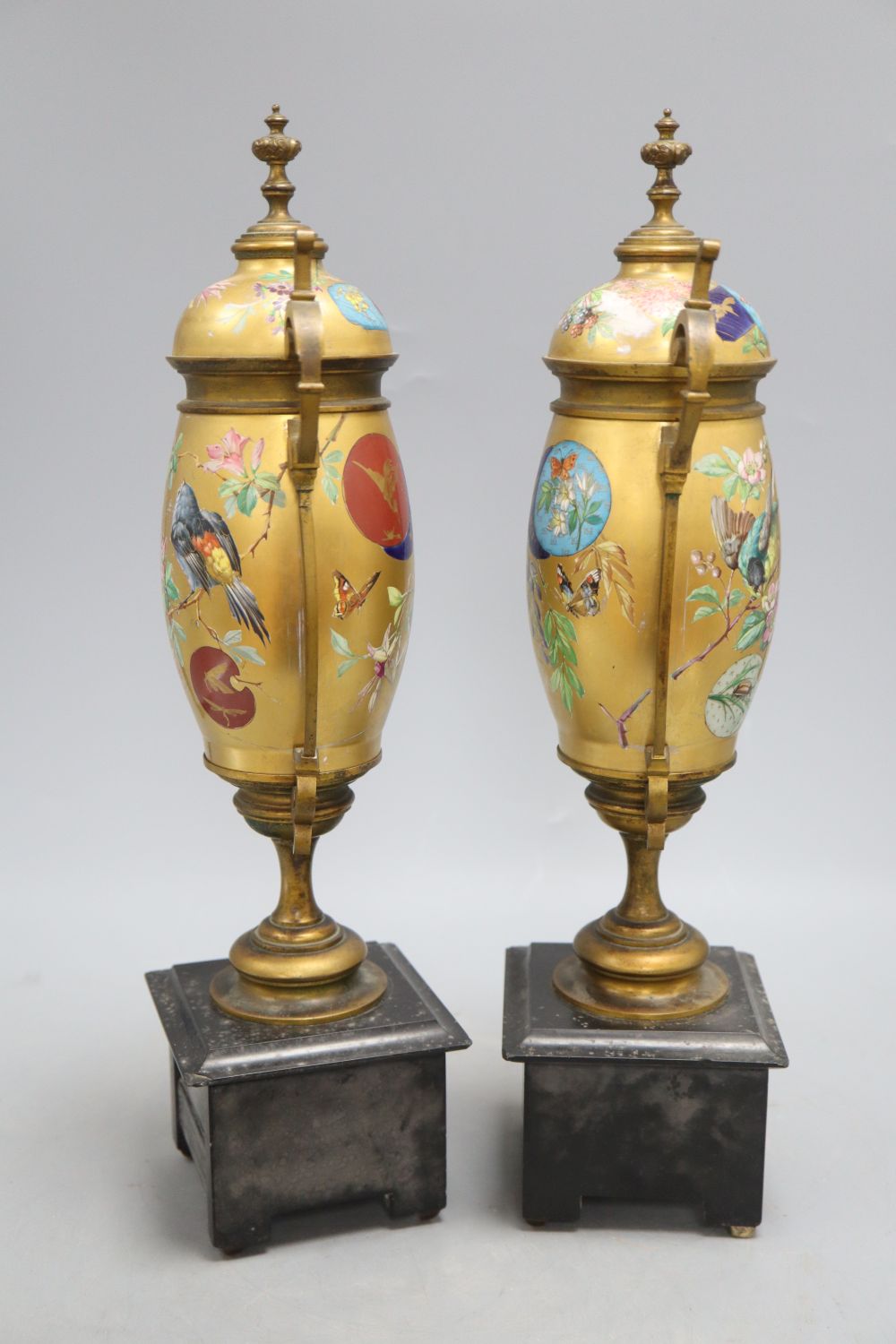 A pair of Victorian Aesthetic movement gilt metal and porcelain vases, height 40cm